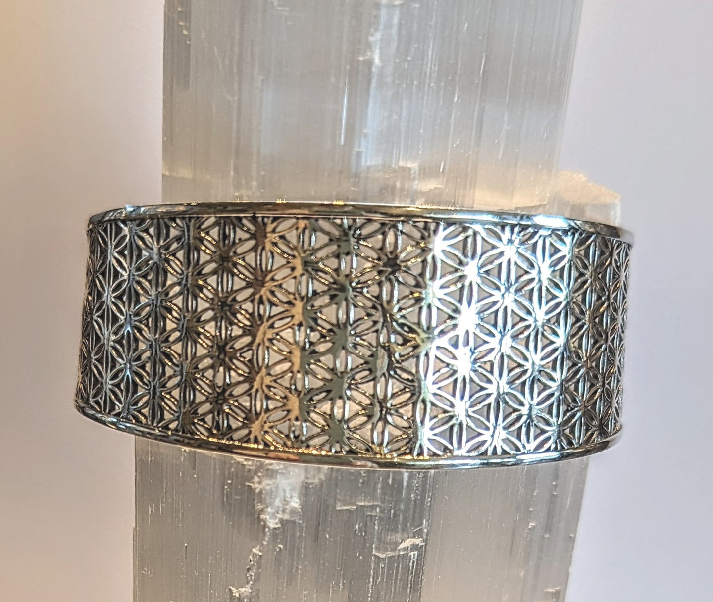 Flower of life design cuff bracelet in sterling silver with rhodium finish.