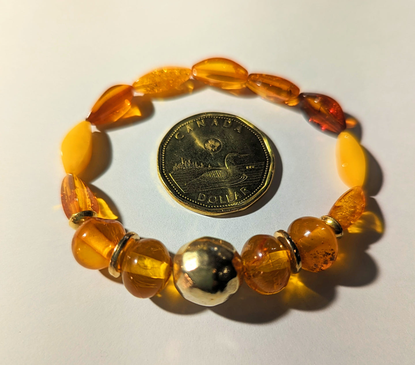 Genuine amber elastic bracelet with gold plated sterling silver beads
