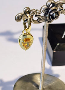 Gold plated sterling silver earrings with yellow cubic center and white enamel