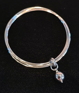 5 bangles in sterling silver with rhodium finish attached with ball charm.