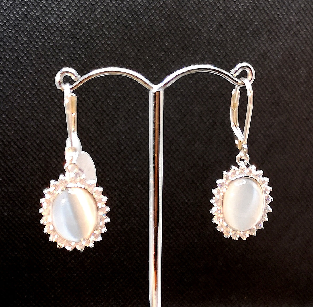 Faux moonstone earring in sterling silver with rhodium finish and cubic.surrounded by micro set cubic