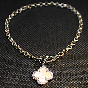 Sterling silver link bracelet with rhodium finish and mother of pearl 4 leaf clover charm