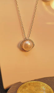 Genuine pearl necklace with micro set cubic in sterling silver with rhodium finish