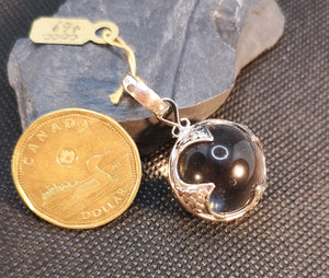 Quartz crystal ball pendant in sterling silver.